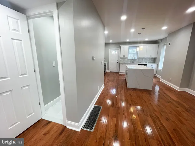 a view of kitchen with wooden floor and electronic appliances