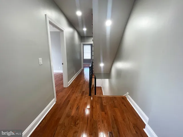 a view of hallway with wooden floor