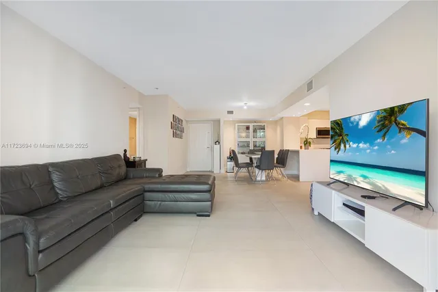 a large white kitchen with a refrigerator and a sink