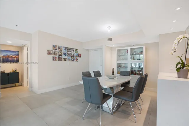 a white toilet next to a bathroom