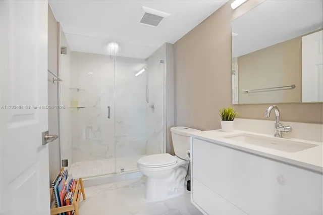 a view of a dining room with furniture and a chandelier