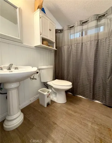 a bathroom with a sink toilet and a mirror