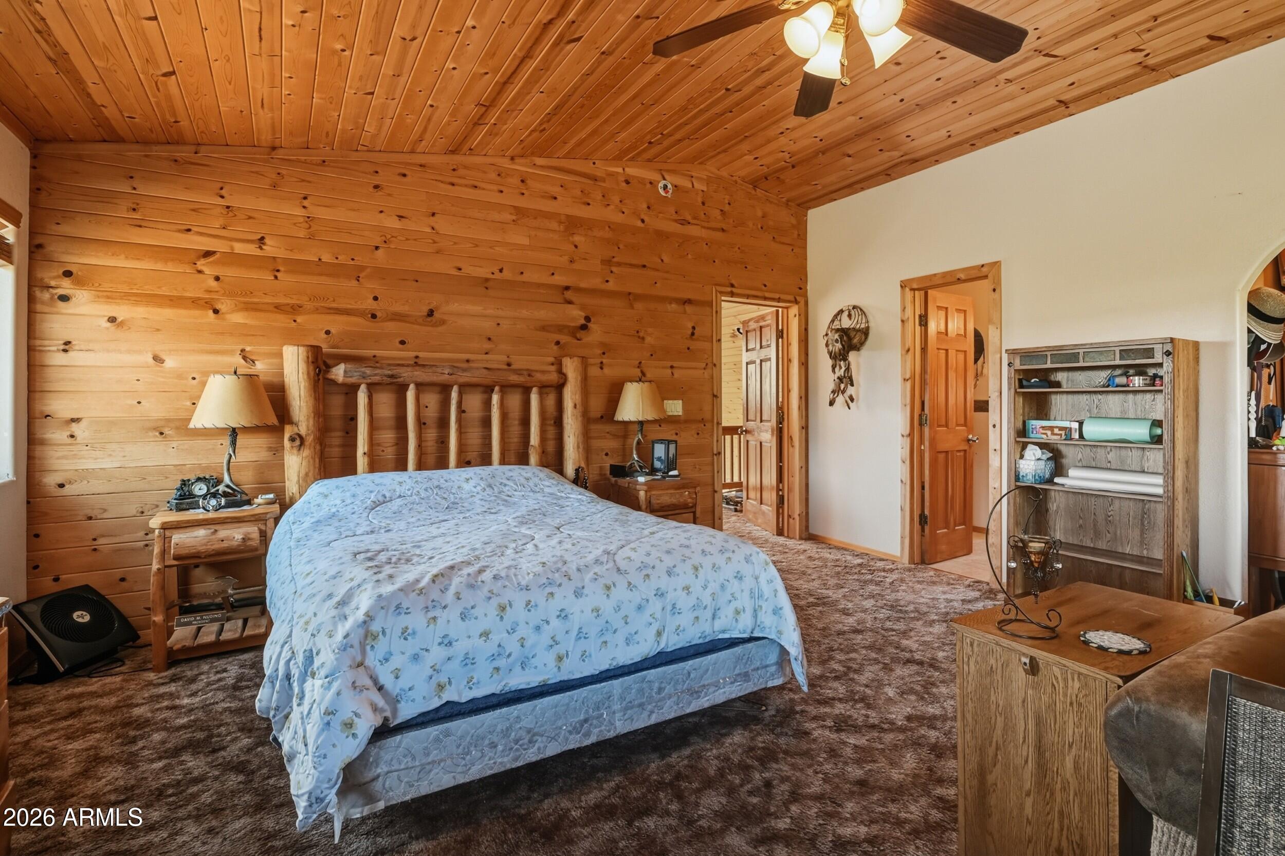 3119 Kysar Way Pine, AZ 85544 - Photo 22 of 68 a bedroom with a bed a table and dresser