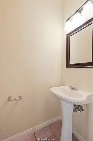a bathroom with a sink a mirror and a vanity