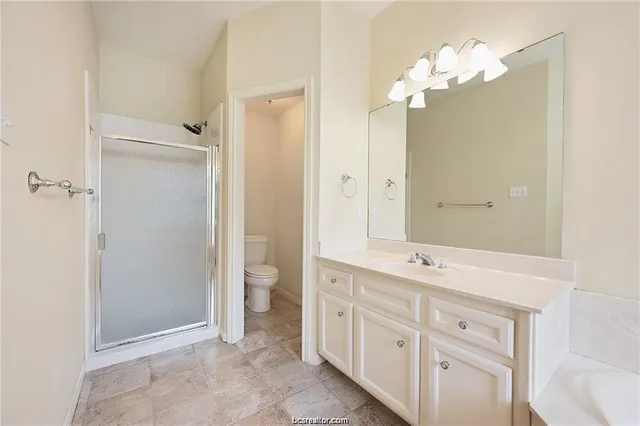 a spacious bathroom with a double vanity sink shower and a mirror