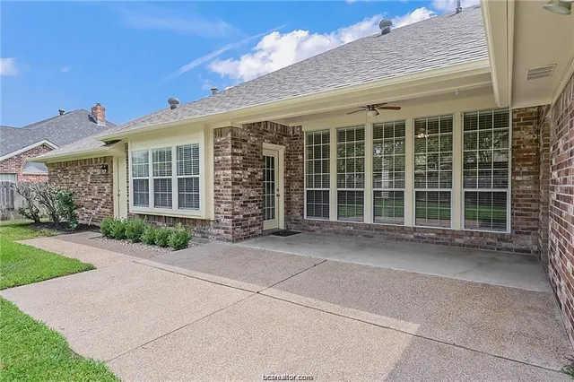 a front view of a house with a large window and yard