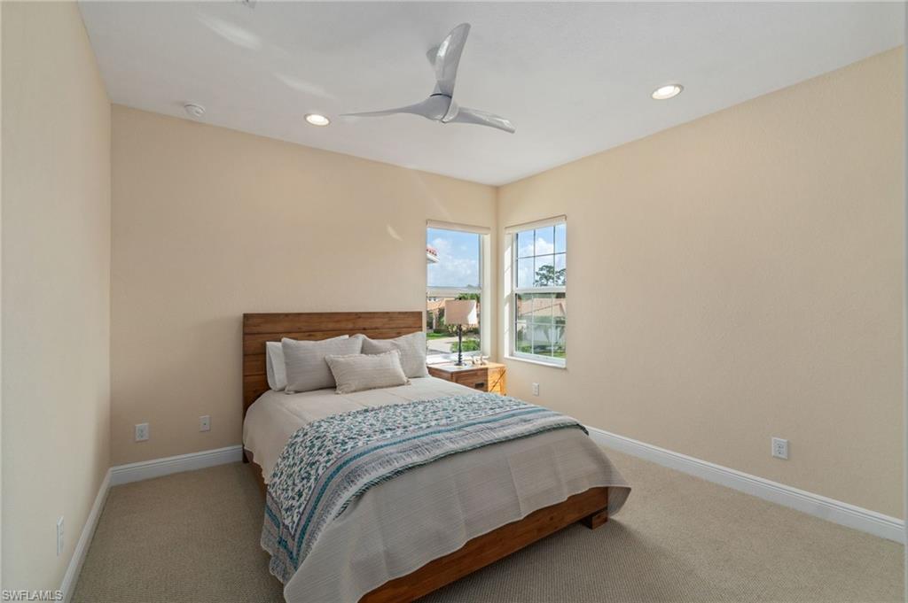 19753 Tesoro Way Estero, FL 33967 - Photo 21 of 47 a bed sitting in a spacious bedroom next to a window