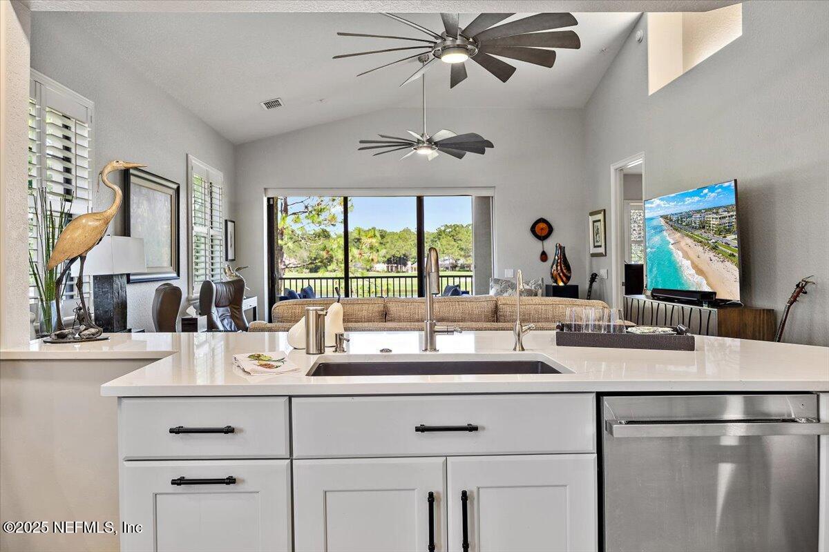 174 Laterra Links Circle, Unit 201 St. Augustine, FL 32092 - Photo 13 of 41 a kitchen with a sink dishwasher a large window with white cabinets