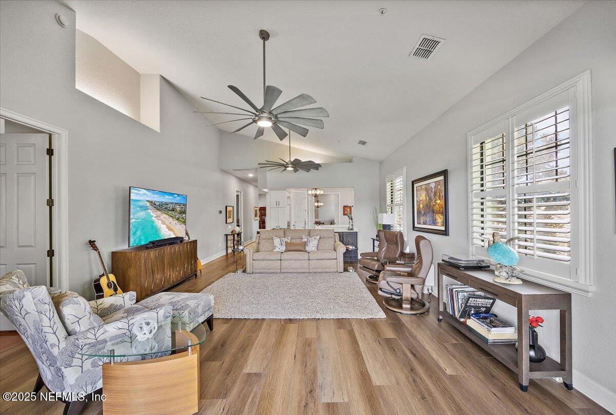 174 Laterra Links Circle, Unit 201 St. Augustine, FL 32092 - Photo 16 of 41 a living room with furniture and a chandelier