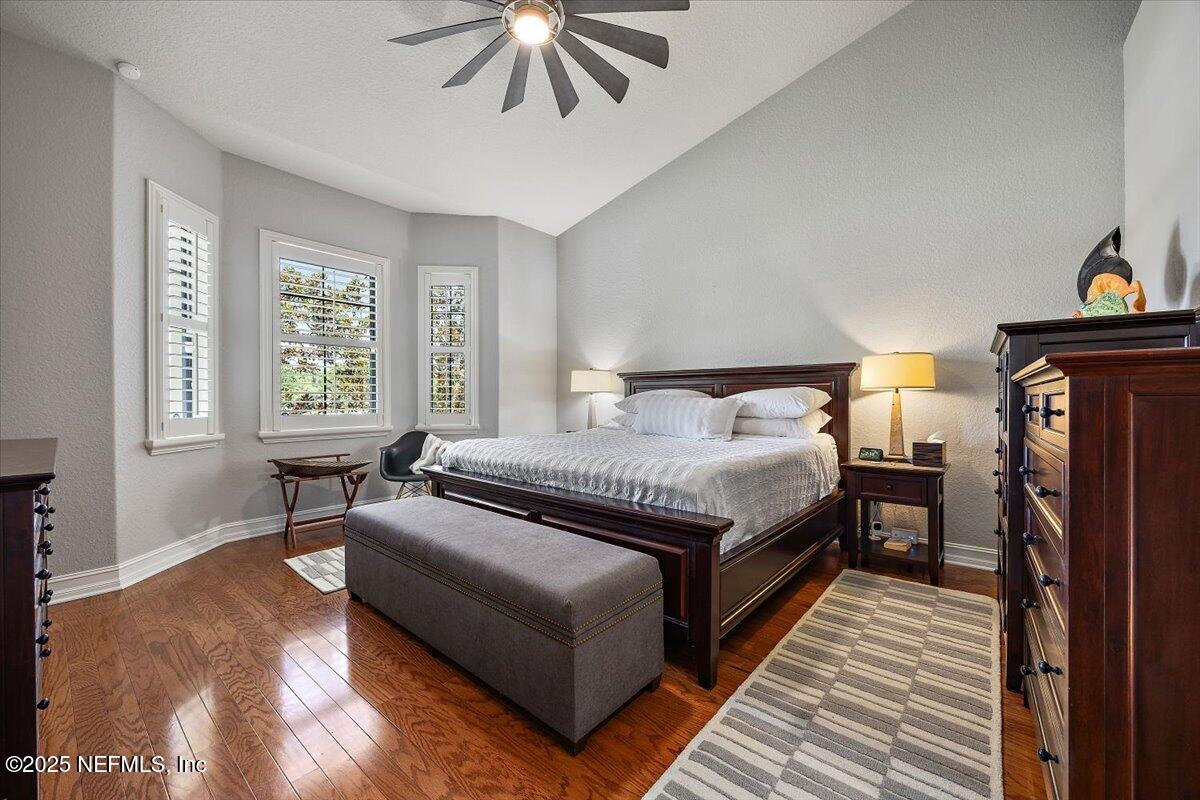 174 Laterra Links Circle, Unit 201 St. Augustine, FL 32092 - Photo 20 of 41 a spacious bedroom with a bed and a chandelier