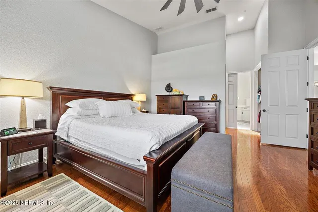 a bedroom with a bed and wooden floor