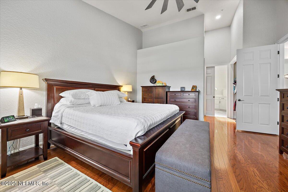 174 Laterra Links Circle, Unit 201 St. Augustine, FL 32092 - Photo 21 of 41 a bedroom with a bed and wooden floor