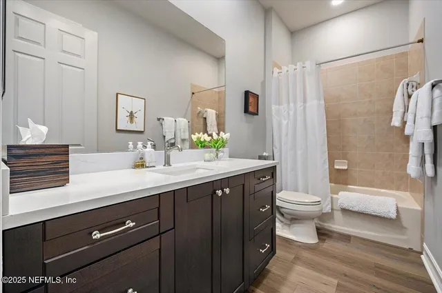 a bathroom with a double vanity sink toilet and shower