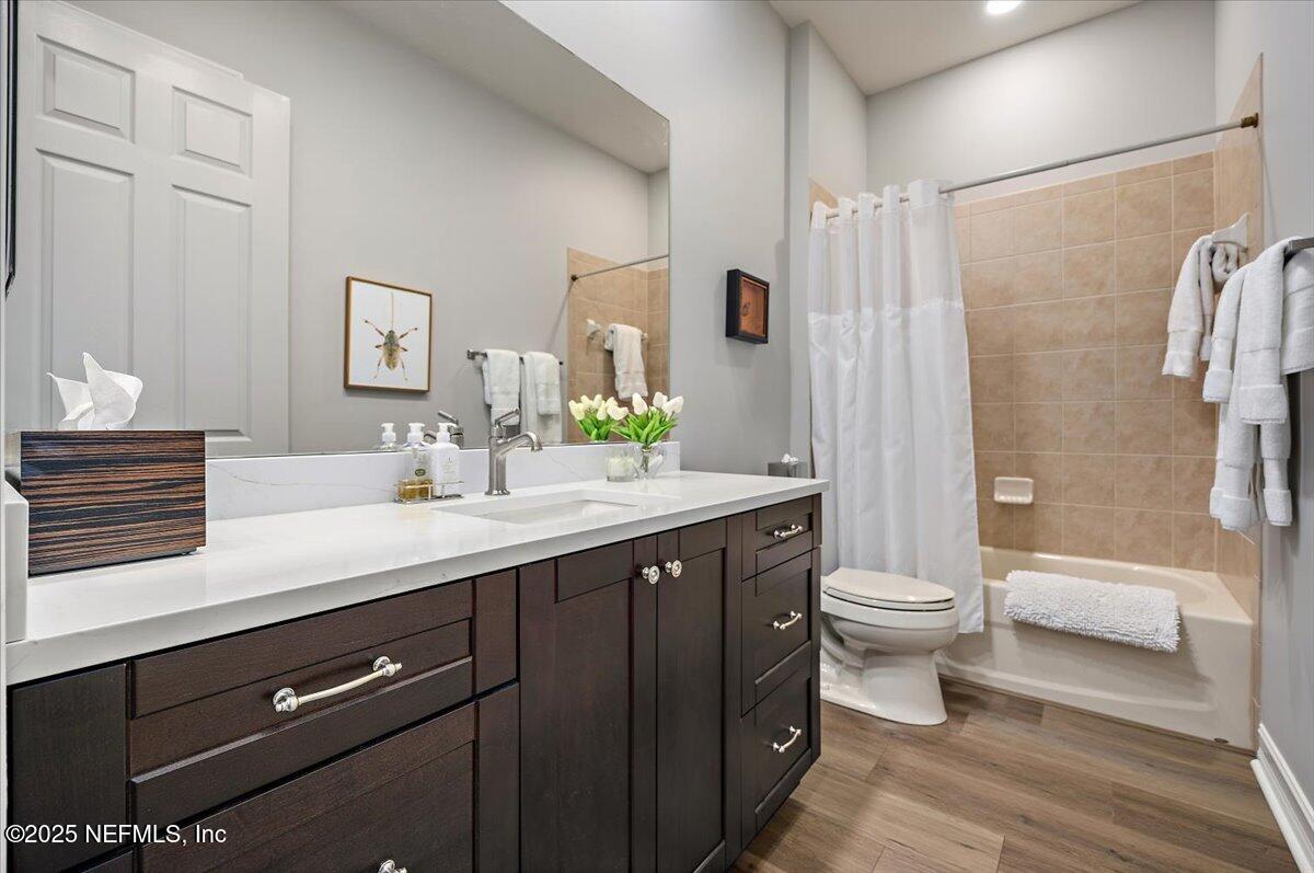 174 Laterra Links Circle, Unit 201 St. Augustine, FL 32092 - Photo 26 of 41 a bathroom with a double vanity sink toilet and shower