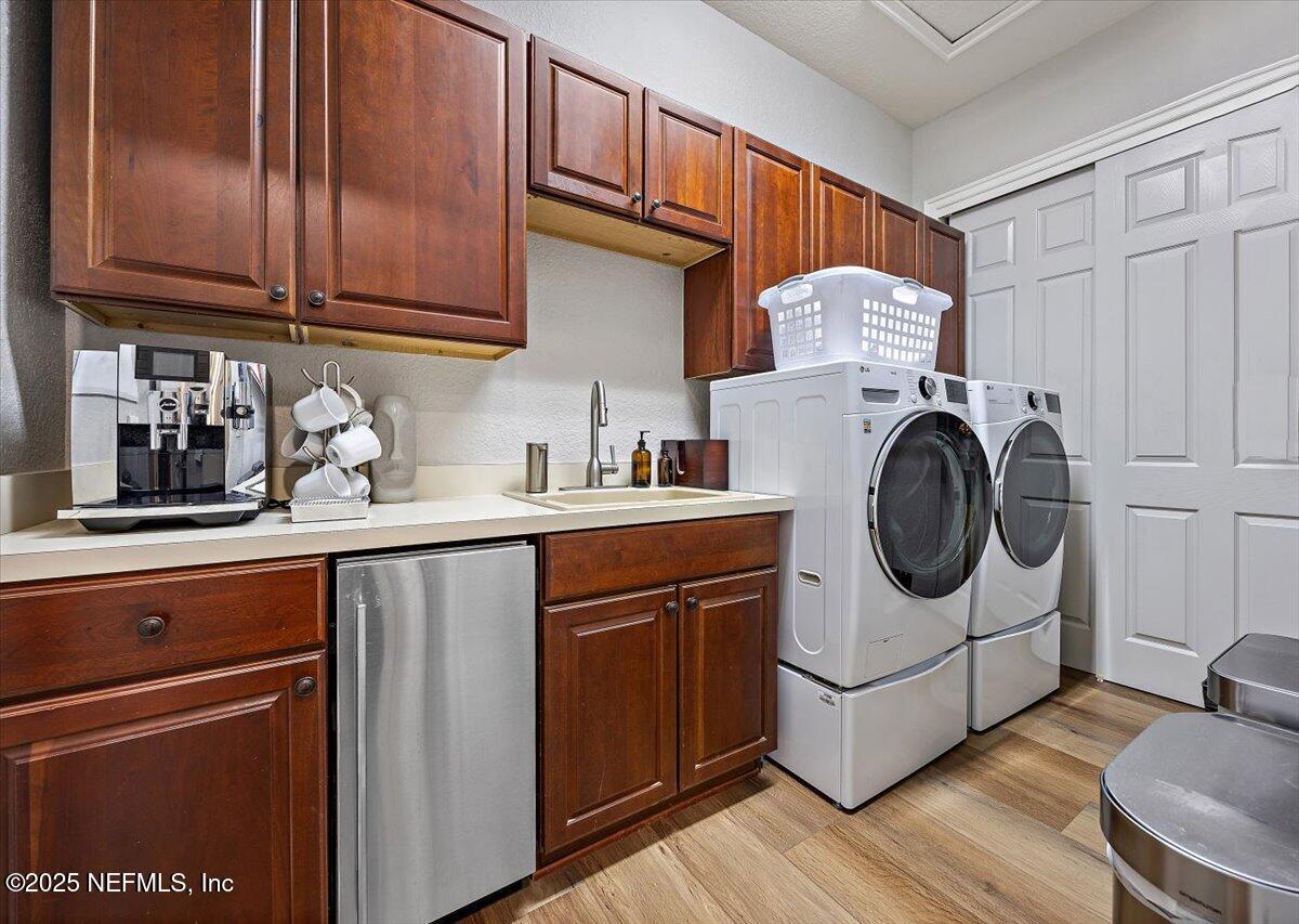 174 Laterra Links Circle, Unit 201 St. Augustine, FL 32092 - Photo 27 of 41 a utility room with sink dryer and washer
