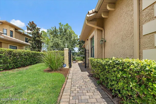 a pathway of a house with a yard