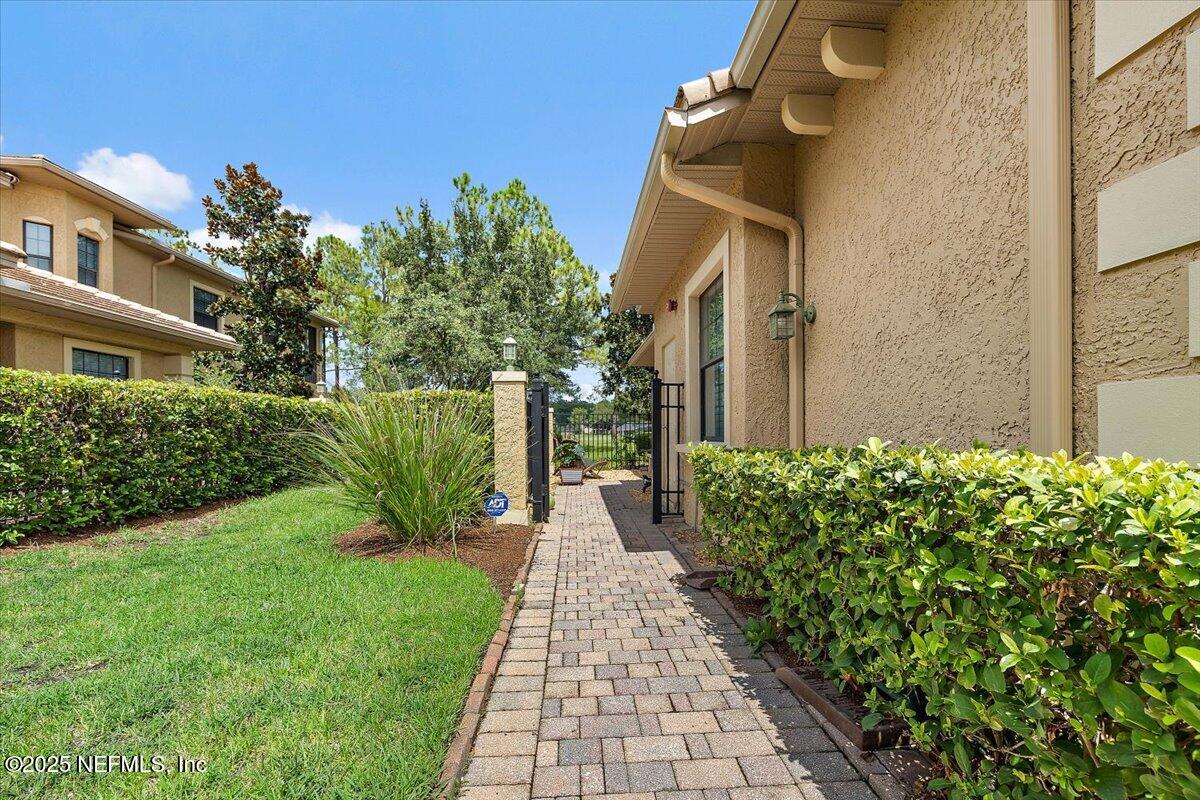 174 Laterra Links Circle, Unit 201 St. Augustine, FL 32092 - Photo 3 of 41 a pathway of a house with a yard