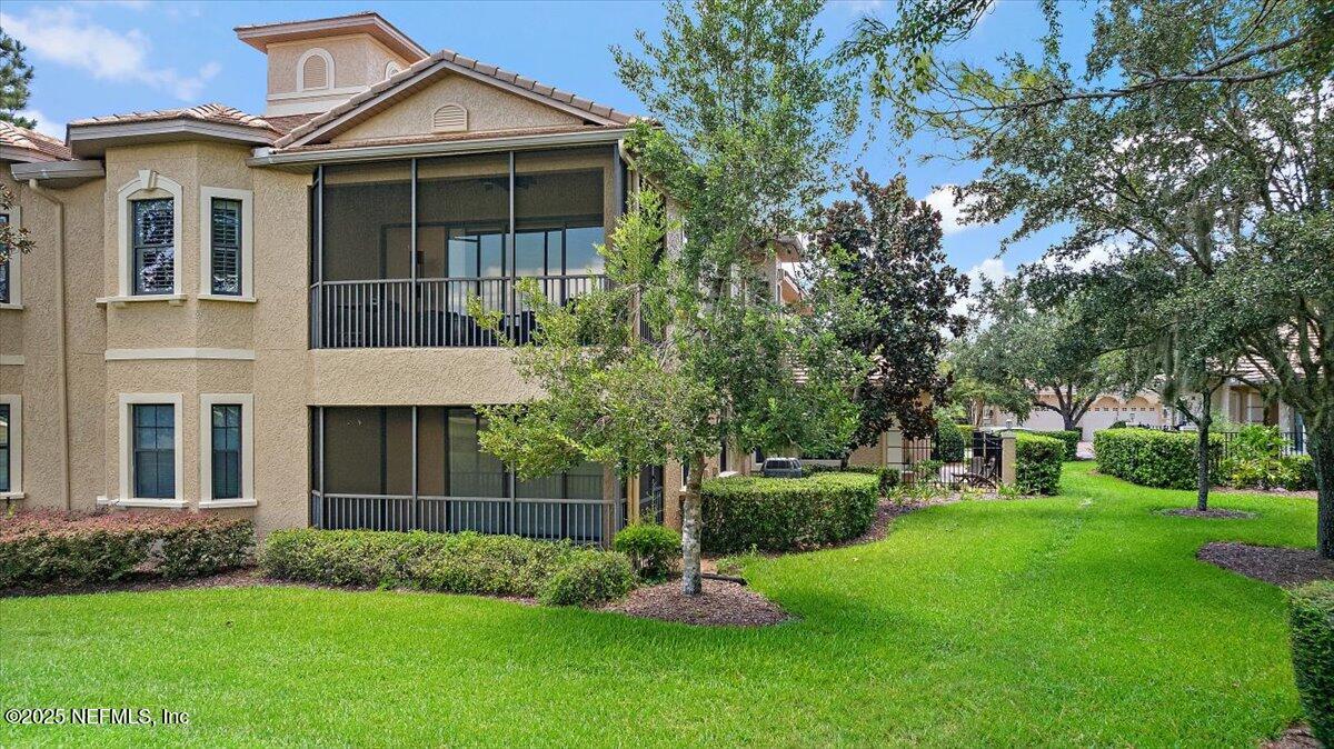 174 Laterra Links Circle, Unit 201 St. Augustine, FL 32092 - Photo 33 of 41 a front view of a house with a garden