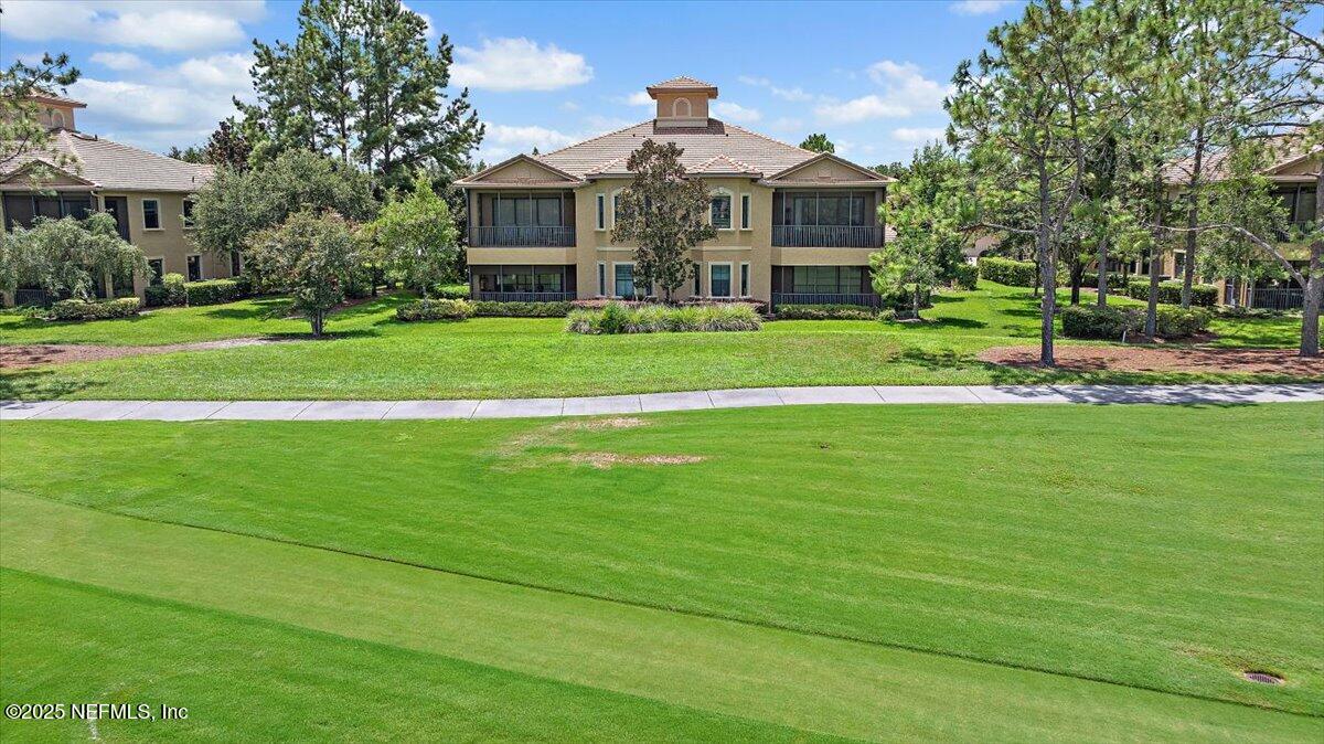 174 Laterra Links Circle, Unit 201 St. Augustine, FL 32092 - Photo 34 of 41 a front view of a house with a yard