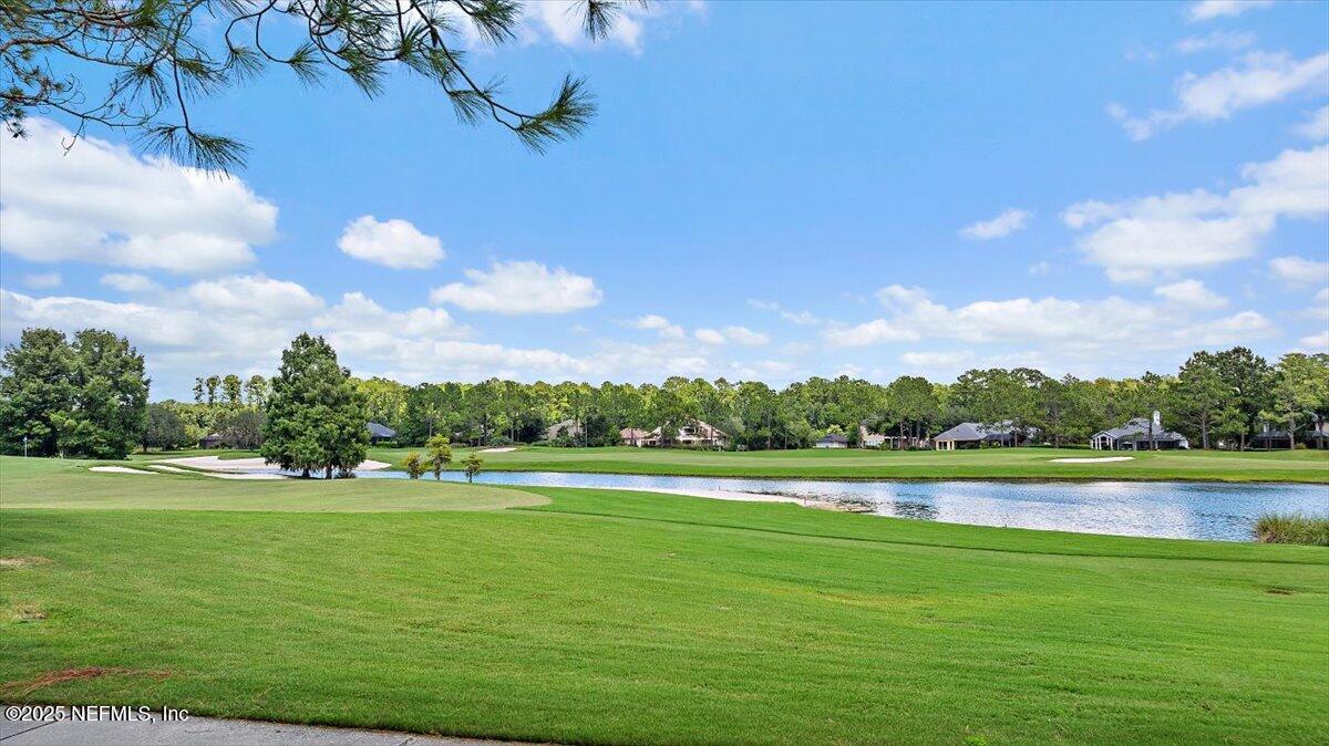 174 Laterra Links Circle, Unit 201 St. Augustine, FL 32092 - Photo 35 of 41 a view of a lake with houses in the back