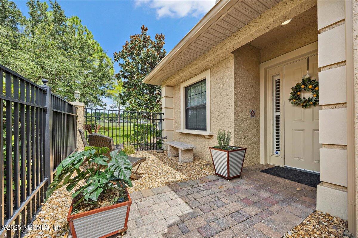 174 Laterra Links Circle, Unit 201 St. Augustine, FL 32092 - Photo 4 of 41 a view of a patio with table and chairs and potted plants