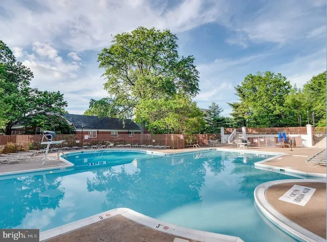 a view of a backyard with swimming pool