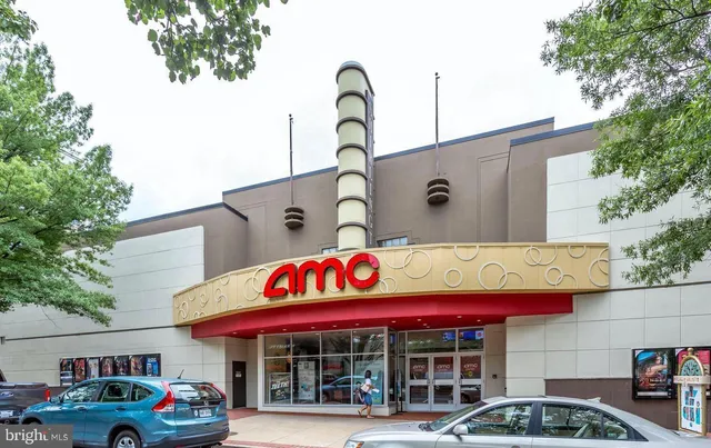a front view of multi story residential apartment building with parking space