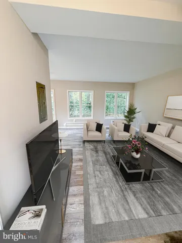 a living room with furniture window and wooden floor