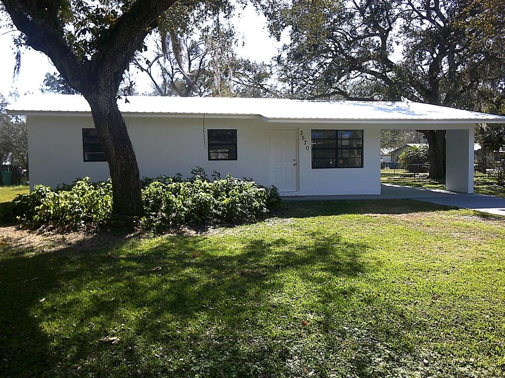 3570 Southwest 18th Street Okeechobee, FL 34974 - Photo 1 of 1 a view of a house with a back yard
