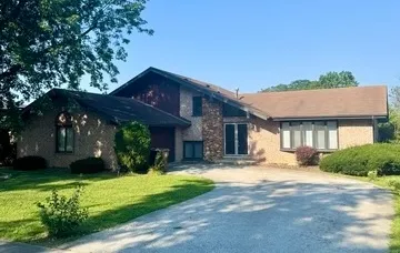 a view of a house with a yard and tree s
