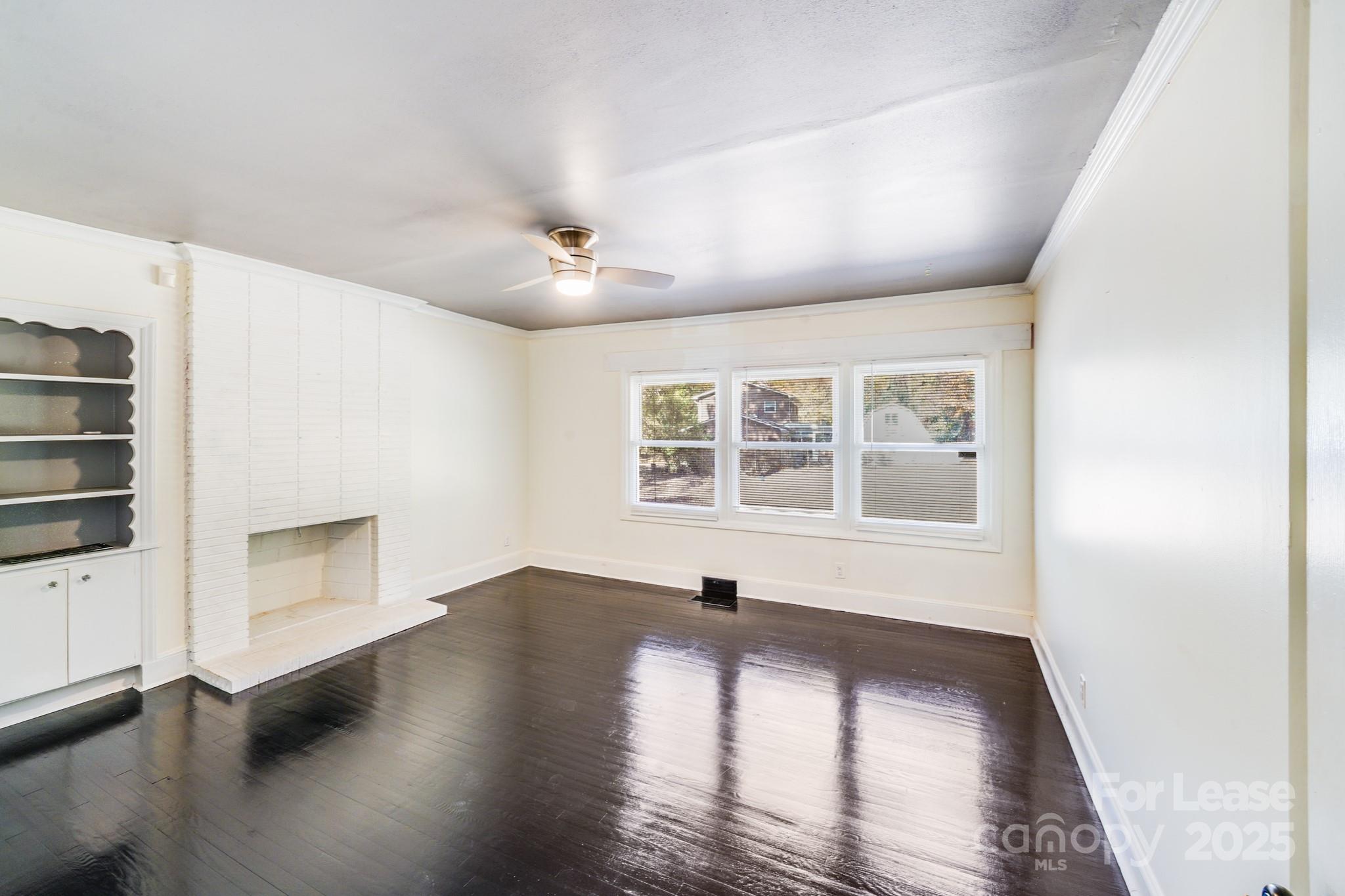 5311 Princess Street Charlotte, NC 28269 - Photo 14 of 24 wooden floor in an empty room with a window