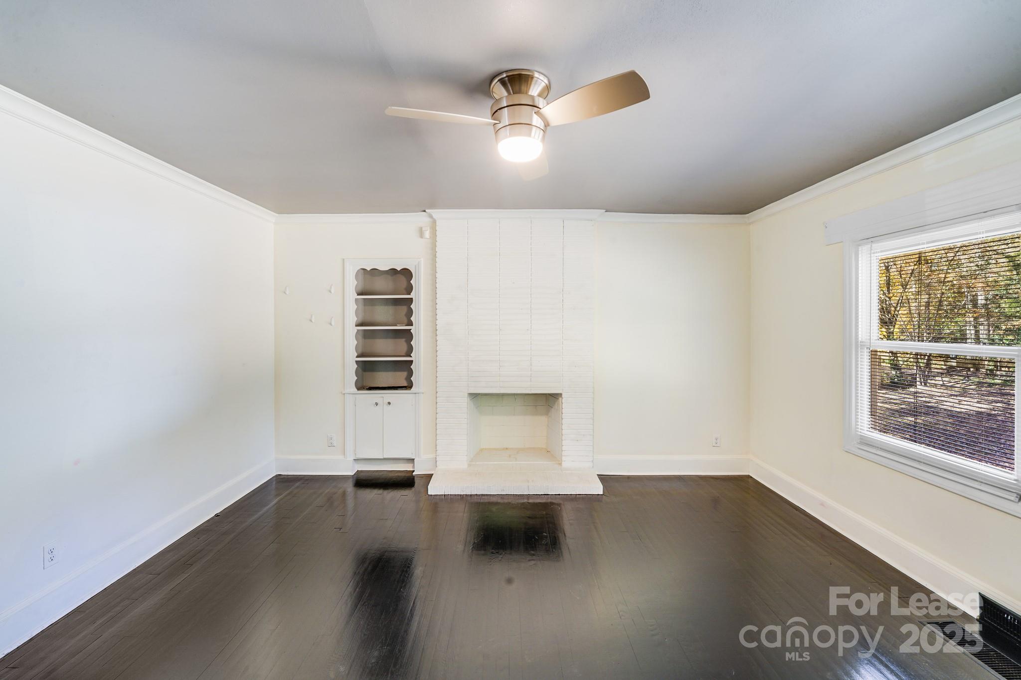5311 Princess Street Charlotte, NC 28269 - Photo 3 of 24 an empty room with wooden floor and windows