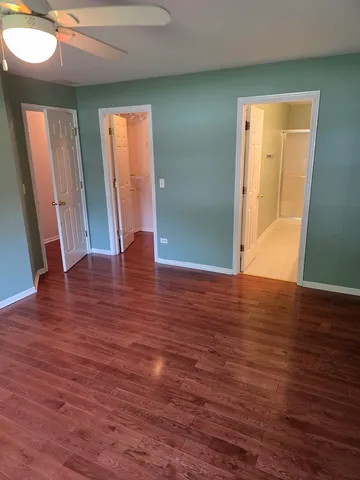 an empty room with wooden floor and front door
