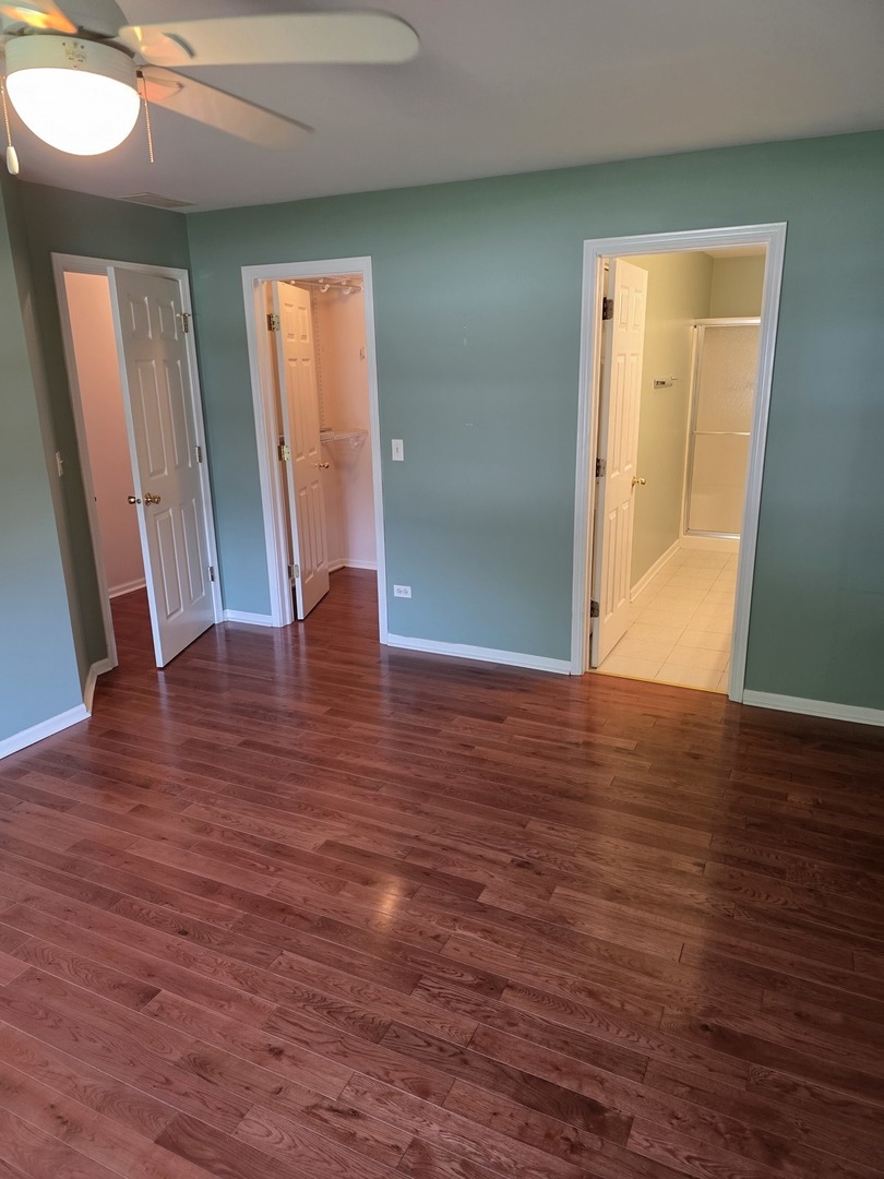 408 Woodview Circle, Unit B Elgin, IL 60120 - Photo 15 of 26 an empty room with wooden floor and front door