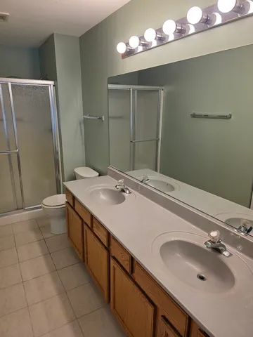 a bathroom with a sink double vanity and a mirror