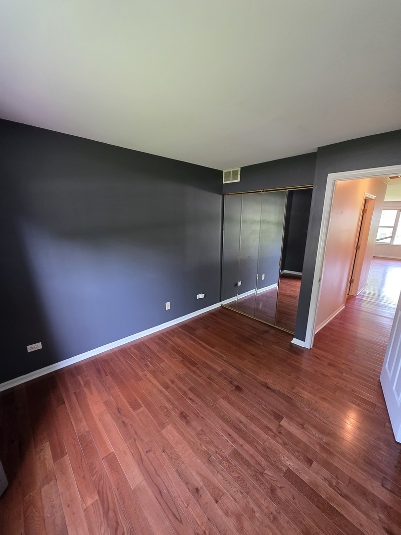 408 Woodview Circle, Unit B Elgin, IL 60120 - Photo 20 of 26 a view of an empty room with wooden floor