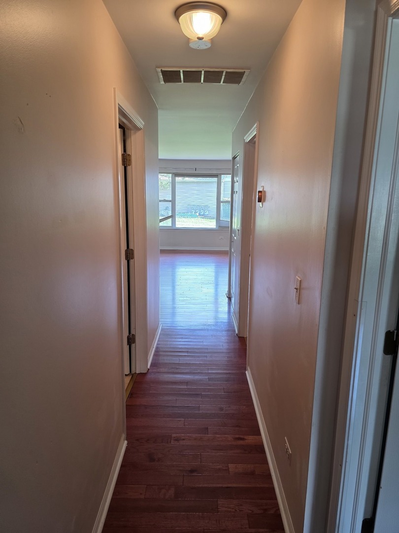 408 Woodview Circle, Unit B Elgin, IL 60120 - Photo 21 of 26 a view of a hallway with wooden floor and staircase