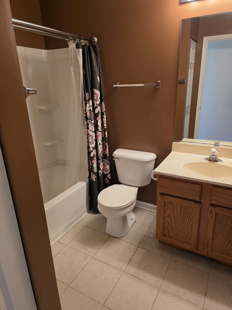 408 Woodview Circle, Unit B Elgin, IL 60120 - Photo 23 of 26 a bathroom with a sink a toilet and shower