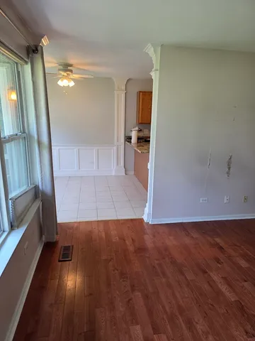 wooden floor in an empty room with a window