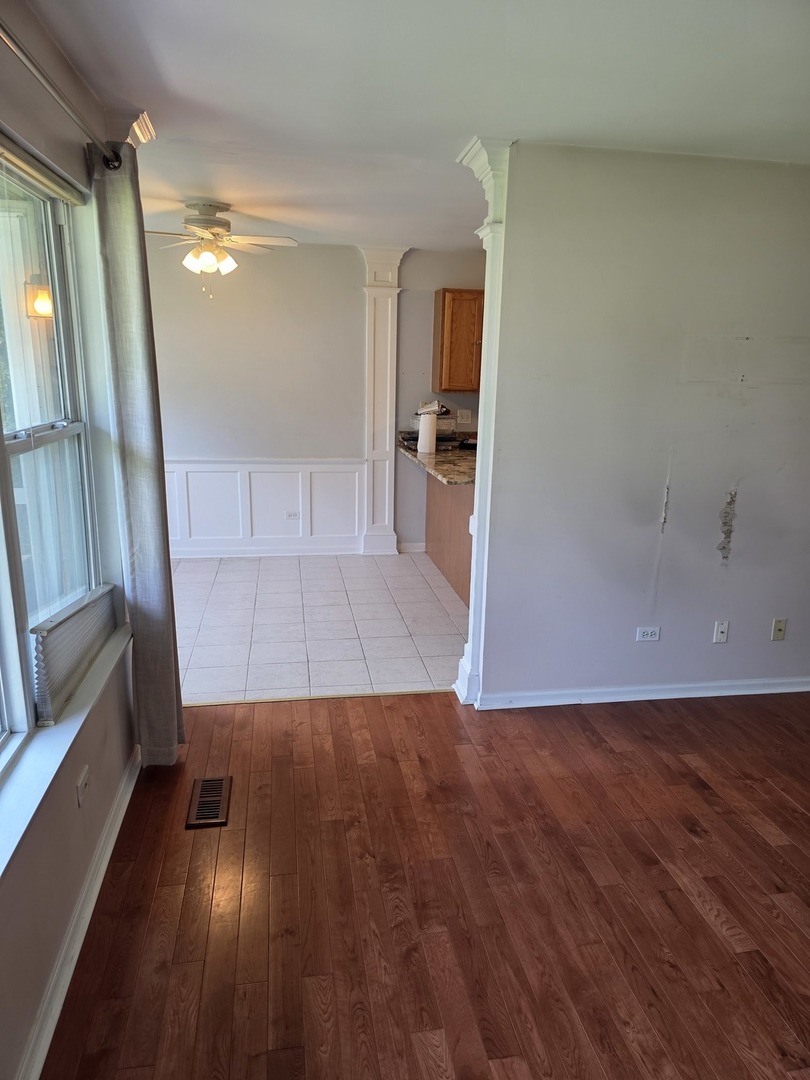 408 Woodview Circle, Unit B Elgin, IL 60120 - Photo 6 of 26 wooden floor in an empty room with a window