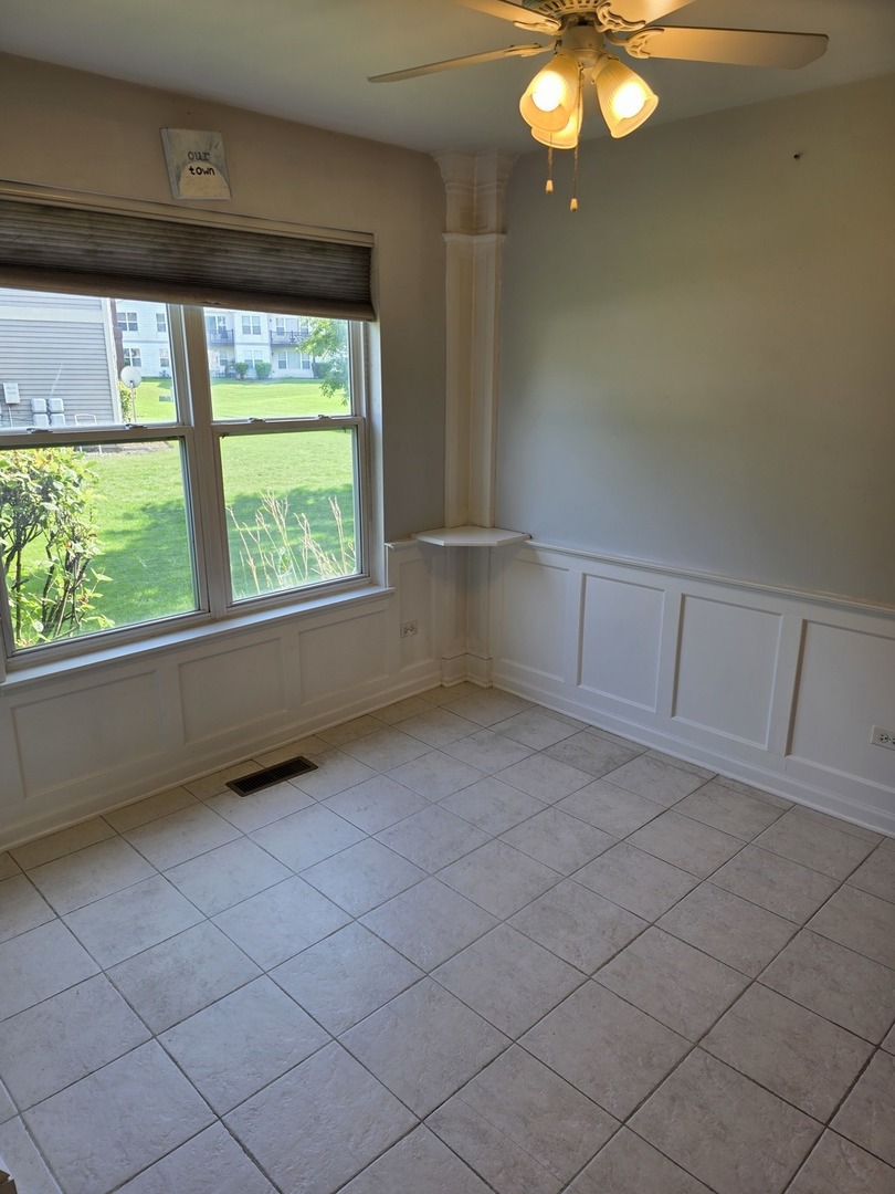 408 Woodview Circle, Unit B Elgin, IL 60120 - Photo 7 of 26 an empty room with windows and outdoor seating