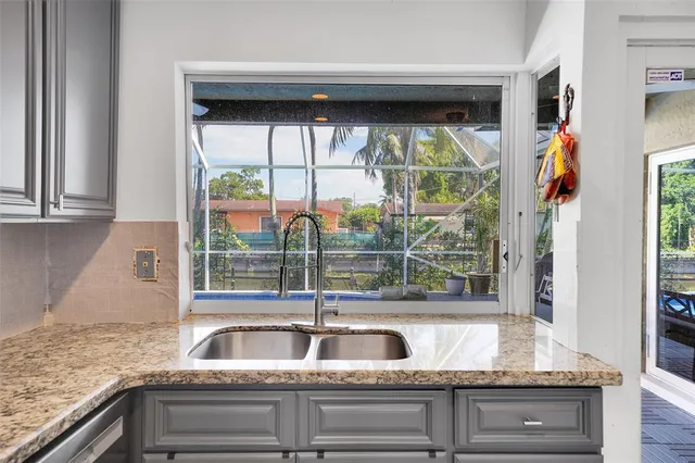 a spacious bedroom with a bed a table and painting on the wall