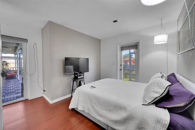 a view of a living room with furniture and floor to ceiling window