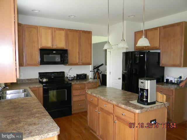 1702 Conrads Ferry Drive Point of Rocks, MD 21777 - Photo 7 of 29 a kitchen with stainless steel appliances granite countertop a sink a stove and a refrigerator