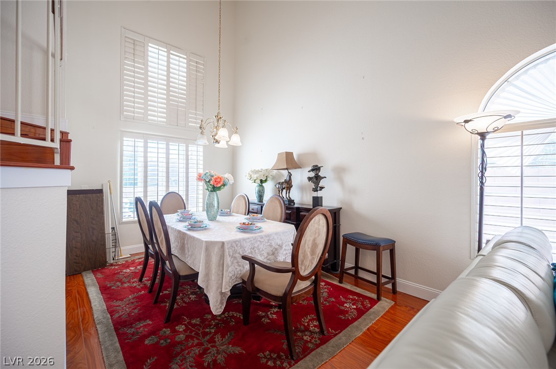 718 Rusty Spur Drive Henderson, NV 89014 - Photo 9 of 50 A formal dining area with soaring ceilings and gleaming hardwood floors awaits gatherings.