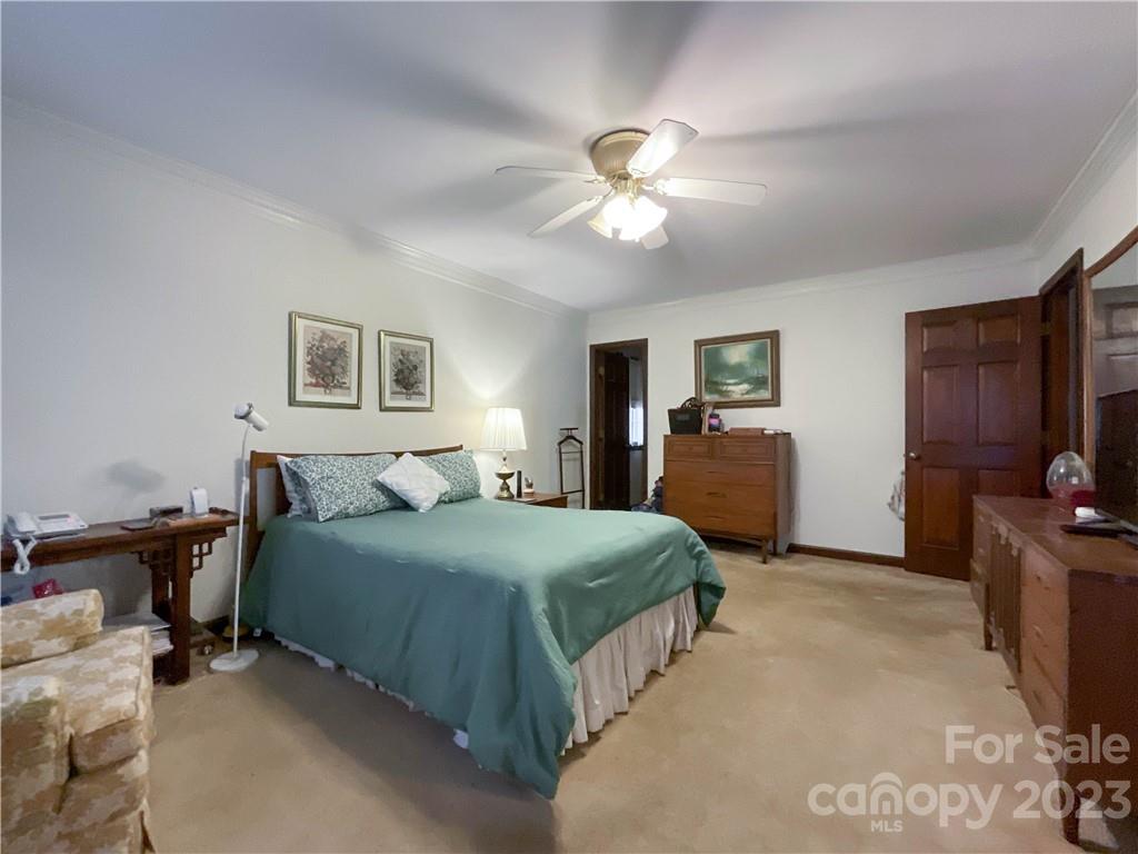 9523 Marvin School Road Marvin, NC 28173 - Photo 20 of 47 a bedroom with a bed and a chandelier