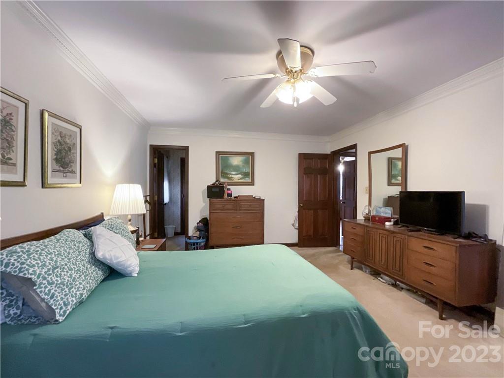 9523 Marvin School Road Marvin, NC 28173 - Photo 21 of 47 a spacious bedroom with a bed and a flat screen tv