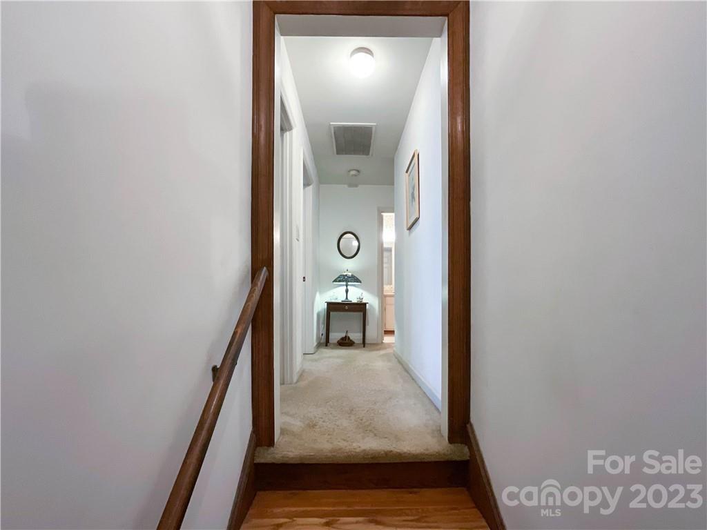 9523 Marvin School Road Marvin, NC 28173 - Photo 26 of 47 a view of a hallway with wooden floor staircase and living room