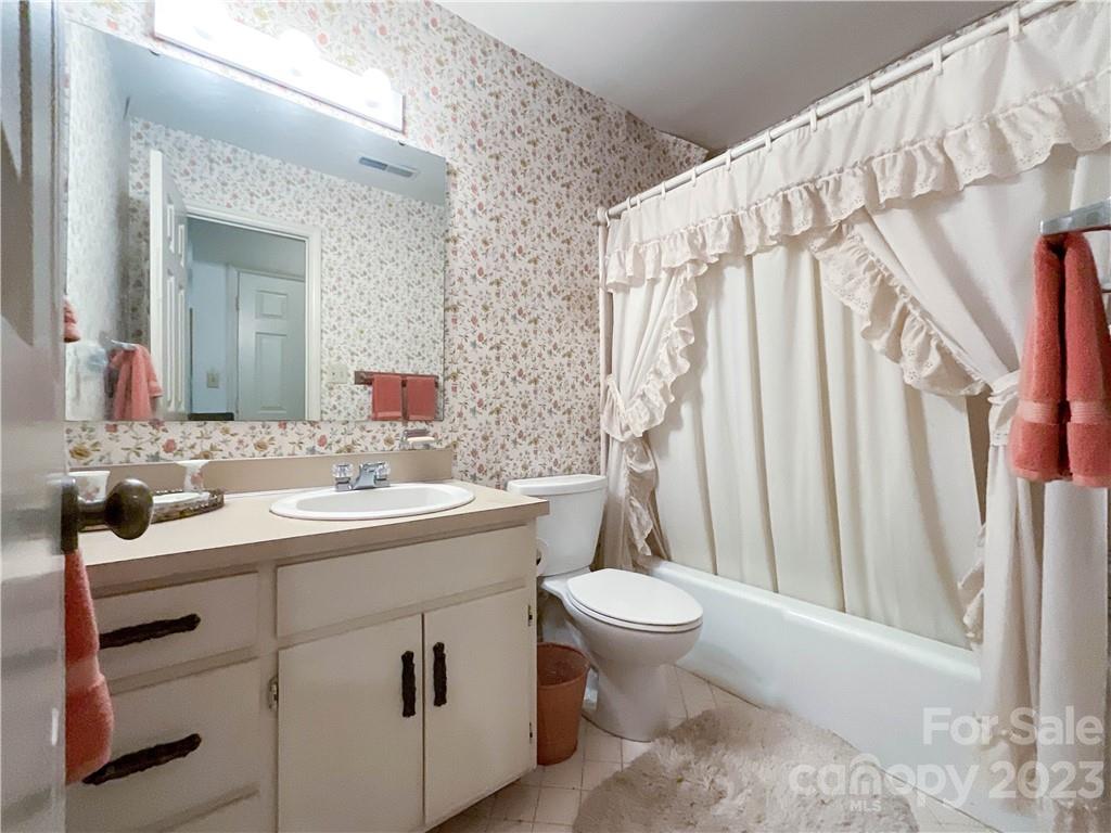 9523 Marvin School Road Marvin, NC 28173 - Photo 31 of 47 a bathroom with a sink a toilet and a mirror