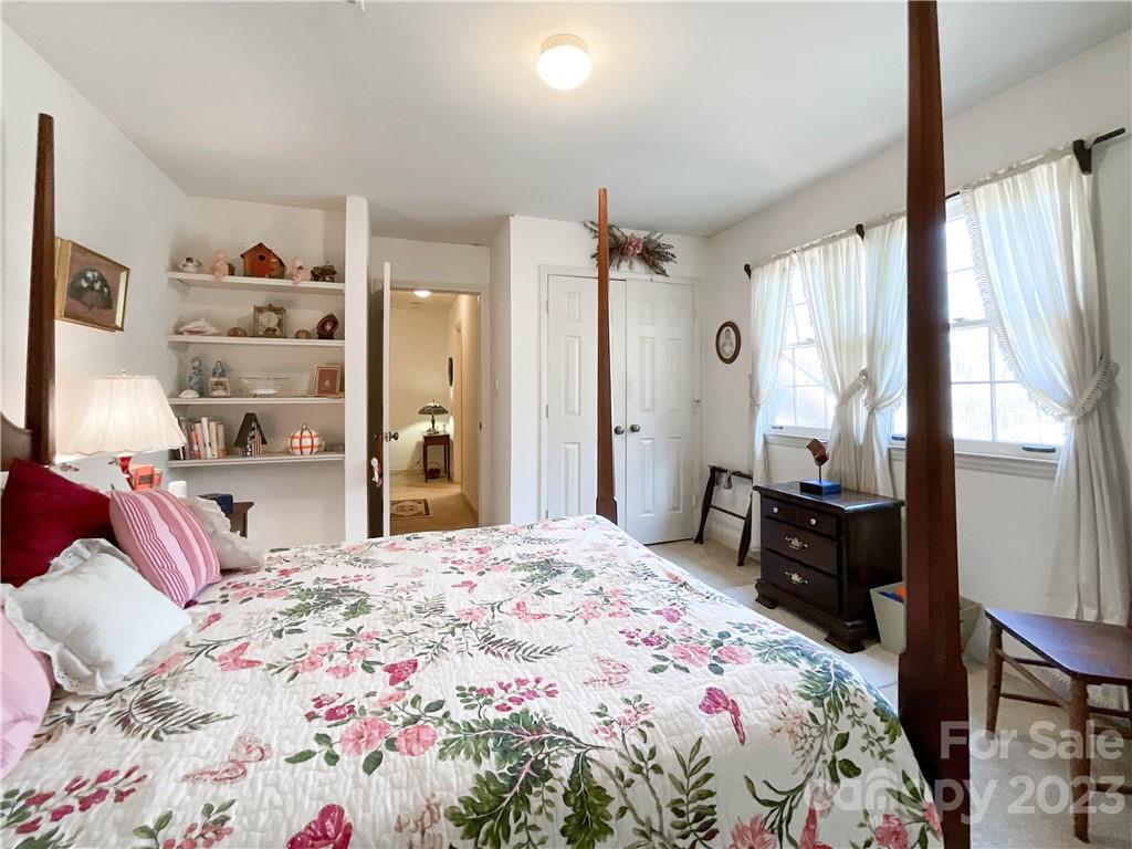 9523 Marvin School Road Marvin, NC 28173 - Photo 35 of 47 a bedroom with a bed and a dresser with mirror